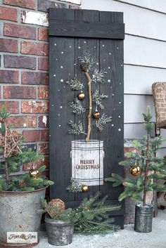 a wooden door decorated with christmas trees and ornaments