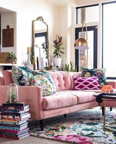 a living room filled with lots of furniture and decor on top of a rug covered floor