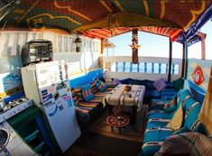 the inside of a bus with lots of furniture and decor on it's roof