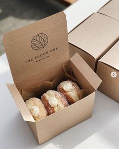 the four boxes have donuts inside of them