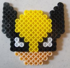 a black and yellow brooch with lots of circles on it's back side