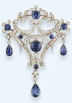 A Belle Epoque sapphire and diamond brooch. The kite-shaped openwork panel set with brilliant-cut diamond scrolls and millegrain-set sapphire accents and central motif, suspending pear-shaped sapphire triple drops, circa 1905, detachable brooch fitting. #BelleÉpoque #brooch 1900's Fashion, Bijoux Art Deco, Fashion Fantasy, Scroll Design