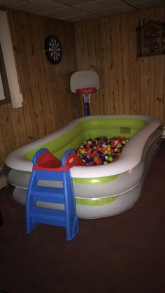 an inflatable pool with balls and ladders for kids to play in it