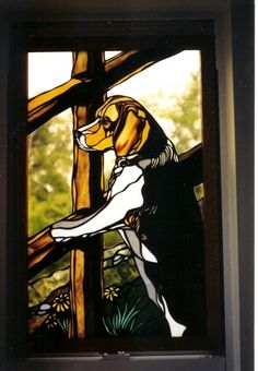 a stained glass window with a dog on it