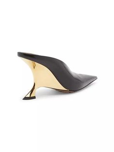 Designed with an intentionally creased exaggerated point toe, Bottega Veneta’s Rocket mules feature a sculpted gold metal heel..Leather upper.Pointed toe.Slip-on style.Leather lining.Padded insole.Rubber sole.Made in Italy.SIZE.Sculpted wedge heel, 3.5' (90mm).This brand fits slightly smaller. Consider ordering a size up..ABOUT THE BRAND.Founded in 1966, the label known for fine Italian craftsmanship with creativity at its core has since catapulted to cult-level status. The house's storied intrecciato pattern in shoes and handbags, alongside its signature minimalist ready-to-wear, have made the label an editor and It-girl favorite..Designed with an intentionally creased exaggerated point toe, Bottega Veneta’s Rocket mules feature a sculpted gold metal heel.Leather upperPointed toeSlip-on s Sleek Gold Leather Heels, Modern Gold Heels With Sculpted Heel, Gold Calf Leather Heels With Pointed Toe, Gold High Heel Calf Leather Heels, Gold High Heel In Calf Leather, Gold Heels With Deep Heel Cup In Modern Style, Modern Gold Heels With Deep Heel Cup, Chic Gold Calf Leather Heels, Calf Leather Wedge Heels For Evening