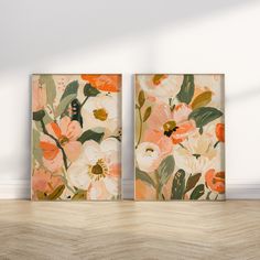 two floral paintings on the wall in an empty room with wood flooring and white walls