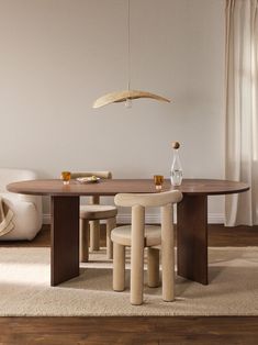 a dining room table and chairs in front of a window