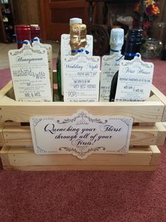 several bottles of wine in a wooden crate on carpeted floor with red carpeting