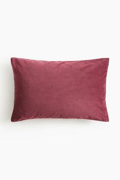 the burgundy velvet pillow is shown on a white background