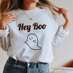 Hey Boo! No tricks here, just a cute ghostly sweatshirt to cozy up in this fall. Printed on a soft on the inside, preshrunk cotton, polyester unisex crewneck sweatshirt. Order 1 or two sizes up for an oversized look and fit. Free shipping for U.S. orders *PLEASE READ INSTRUCTIONS BEFORE PURCHASING* PLACING YOUR ORDER * Choose your Sweatshirt color * Choose your size * PLEASE make sure all your order's steps are complete. PRODUCT DETAILS A sturdy and warm sweatshirt bound to keep you warm in the Funny Long Sleeve Tops For Fall, Novelty White Tops For Fall, Funny White Long Sleeve Tops, Trendy White Halloween Sweatshirt, Funny Long Sleeve Sweatshirt For Fall, White Long Sleeve Halloween Sweatshirt, White Long Sleeve Halloween T-shirt, White Long Sleeve T-shirt For Halloween, White Long Sleeve Fun Sweatshirt