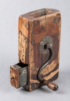 an old wooden box with a metal handle