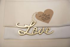 a love tag hanging from the side of a white shirt