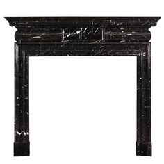 a black marble fireplace surround with an intricate design on the top and bottom, along with a white background