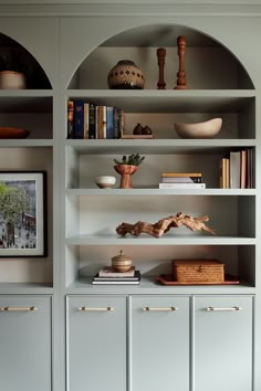 the shelves in this room are filled with books and other things on top of them