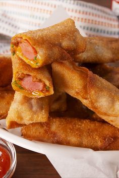 some fried food is stacked on top of each other with ketchup and mayonnaise