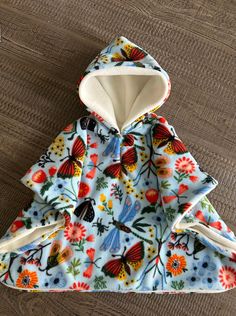 the hoodie is made out of fabric with flowers and butterflies on it