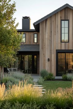 a house that is made out of wood and has glass windows on the front door