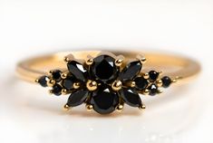 10k Gold Flower Design Black Onyx Ring, Stacking Inset Faceted Onyx Engagement Ring, Dainty Floral Cluster Ring,Handmade Gemstone women Ring.  ITEMS SPECIFICATIONS Material: 10k Gold Hallmark: 10K Top width:7mm Bottom Width: 1.2mm Gemstone: Black Onyx The Ring Comes in 36 Sizes: 4 US/CA UK Size-H Inside Diameter-14.88mm 4 1/4 US/CA Uk size-H+ Inside Diameter-15.07 4 1/2 US/CA UK size-I Inside Diameter-15.29mm 4 3/4 US/CA Uk Size-J Inside Diameter-15.49mm 5 US/CA Uk Size-J+ Inside Diameter-15.7mm Elegant Black Cluster Ring As A Gift, Heirloom Black Jewelry With Prong Setting, Black Multi-stone Wedding Rings, Black Multi-stone Rings For Anniversary, Black Multi-stone Round Rings, Black Multi-stone Anniversary Rings, Black Multi-stone Ring, Formal Black Multi-stone Rings, Fine Jewelry Multi-stone Flower Ring Gift