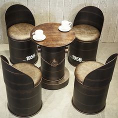 four chairs and a table with coffee cups on them, all around the same chair