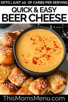 a bowl of beer cheese next to bread rolls on a plate with text overlay that reads quick and easy beer cheese