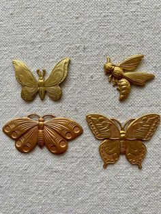 four different types of gold butterfly brooches