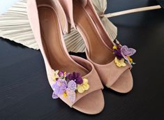 a pair of pink high heels with flowers on them