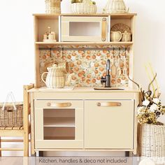 a kitchen with an oven, microwave and other items on the counter top in front of a white wall