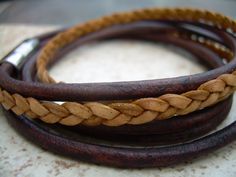 A rich and and tasteful double wrap leather bracelet in perfect Fall colors... This bracelet style features 3 strands of Fine Premium Quality - 5mm flat braided and 3mm round leather cords. A secure stainless steel magnetic closure clasp serves as a focal point, ( 20 mm or approx 3/4 inch in length) for easy on and off. All dyes used in our leather are certified 100% Lead-Free and meet all requirements of the German Goods Ordinance, REACH (European Union), RoSH (U.K.), and CPSIA (U.S.) which req Adjustable Double Band Brown Wrap Bracelet, Brown Double Band Bracelet With Leather Strap, Brown Double Band Leather Bracelets, Brown Double Band Leather Strap Bracelets, Brown Leather Strap Double Band Bracelets, Men's Leather Bracelet, Bracelets Leather, Natural Braids, Men's Bracelets