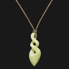 a green necklace with a twisted design on the front and back end, hanging from a rope