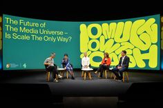 four people sitting on chairs in front of a large screen with the words'what is social universe - is scale the only way? '