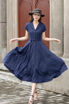 "This vintage-inspired short-sleeved shirt dress is the perfect addition to any retro lover's wardrobe! Featuring a classic collared neckline, front button closure, and a flattering A-line silhouette, this dress is both timeless and trendy. The elegant shade of blue is sure to turn heads and the lightweight fabric makes it perfect for warmer weather. DETAILS *  100% linen *  Two side pockets *  Front Button up closure *  Belted dress *  Short sleeve *  Notched collar *  Below knee Length *  Perf Short Sleeve Vintage Fashion Dresses For Spring, Spring Vintage Fashion Short Sleeve Dresses, Vintage Fashion Spring Dress With Short Sleeves, Short Sleeve Vintage Dress For Spring, Short Sleeve Vintage Dress For Summer, Summer Vintage Dress With Short Sleeves, Vintage Style Short Sleeve Midi Dress, Vintage Short Sleeve Midi Dress, Vintage Short Sleeve Midi Dress For Vintage Fashion