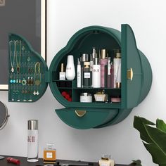 a green shelf filled with lots of cosmetics and personal care items next to a mirror