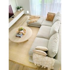 a living room filled with furniture and a flat screen tv on top of a hard wood floor