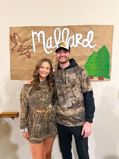 a man and woman standing in front of a sign