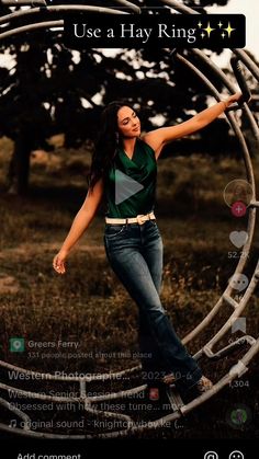 a woman standing in front of a metal sculpture with her arms out and hands outstretched