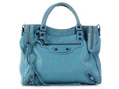 Made of slouchy, veiny, distressed turquoise leather, this squarish satchel has a zipped pocket in front, while the double zippers on top open up to reveal black fabric lining with another zipped pocket inside. Designer Blue Soft Leather Bags, Designer Soft Leather Blue Bags, Designer Blue Soft Leather Shoulder Bag, Designer Blue Satchel For Travel, Luxury Blue Soft Leather Satchel, Designer Blue Shoulder Bag With Leather Lining, Blue Luxury Textured Leather Satchel, Luxury Blue Textured Leather Satchel, Blue Textured Leather Travel Satchel