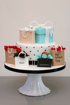 a three tiered cake with shopping bags on it