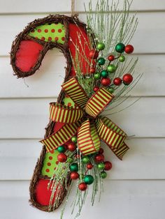 a number decorated with christmas decorations on the front of a house and hanging from a wall