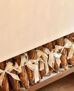 a bunch of doughnuts are lined up in a row with ribbons on them