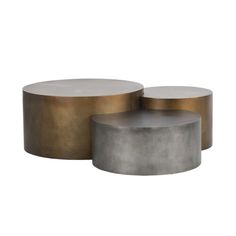 two round tables with metal bases on each side and one in gold, the other in grey