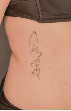 a woman's stomach with a small tattoo on her lower back, and an outline of a dog