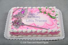 a birthday cake with pink frosting and a tiara on top