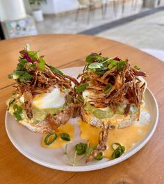 an open faced sandwich on a white plate