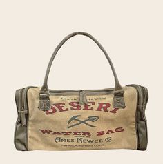 "Desert Waterbag Duffle/Travel Bag American Glory are meticulously handcrafted Handbags & Accessories, inspired by history... vintage posters, advertisements and burlap sack designs are nostalgic and gives a connection to America's past. Travel in style... this travel bags artwork replicates a Desert Water Bag, between the 1920s to the 1960s bag was filled with water, hung on the outside of cars and ready to douse the radiator if it overheated, or quench the thirst of the driver. Before you set off on your own adventures remove straps to carry bag by the leather handles, or keep them on to sling it across your shoulder as a cross-body. Plenty of room inside this bag for all of your clothes along with 2 large external pockets, zippered back pocket to quickly go in and out of and 3 more inte 70s Duffle Bag, Vintage Luxury Bag With Waxed Finish, Vintage Bags For Outdoor With Large Capacity, Vintage Large Capacity Bag For Outdoor, Vintage Large Capacity Outdoor Bag, Vintage Large Capacity Shoulder Bag For Outdoor, Vintage Bags With Large Capacity For Outdoor, Vintage Large Capacity Canvas Bag For Outdoor, Vintage Canvas Bag With Large Capacity For Outdoor