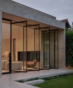 an open living room with glass walls and sliding doors