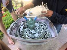 two people working on something in a bucket