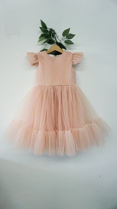 "Perfect first birthday party dress This dress is made of soft blush pink tulle. It is fully lined with soft satin lining. The dress has short butterfly tulle sleeves. The skirt is full and fluffy. -------------------------------- Bodice: Material - soft blush pink satin Lining - 100% cotton fabric Back - zipper back Skirt: Material - tulle Lining - satin Length - knee-length -------------------------------- SIZE Chart size 6-12m - chest 19.5, length 18\" size 1T - chest: 20\" , length 19.5 size Elegant Dress For First Birthday In Spring, Elegant Spring Dress For First Birthday, Peach Ruffled Dresses For Wedding, Peach Ruffled Wedding Dress, Elegant Tulle Fairy Dress For Baptism, Elegant Spring Fairy Dress For Birthday, Elegant First Birthday Summer Tutu Dress, Cute Flutter Sleeve Party Dress, Cute Flutter Sleeve Dress For Party