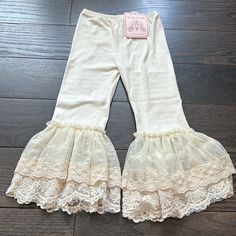 Ivory Legging With Lace And Tulle Bell Bottoms By Frilly Frocks (A Division Of Haute Baby). Beige Bottoms With Lace Trim Flowy Design, Cute Cream Cotton Bottoms, Fitted Cream Bottoms With Ruffles, Fitted Cream Bottoms With Lace Trim, Beige Lace Bottoms With Crochet Trim, Vintage White Lace Bottoms, Ivory Leggings, Baby Ruffle Pants, Frilly Baby Pants