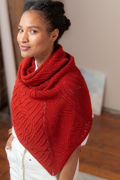 a woman wearing a red knitted shawl