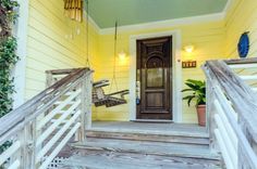 a porch with stairs leading up to the front door